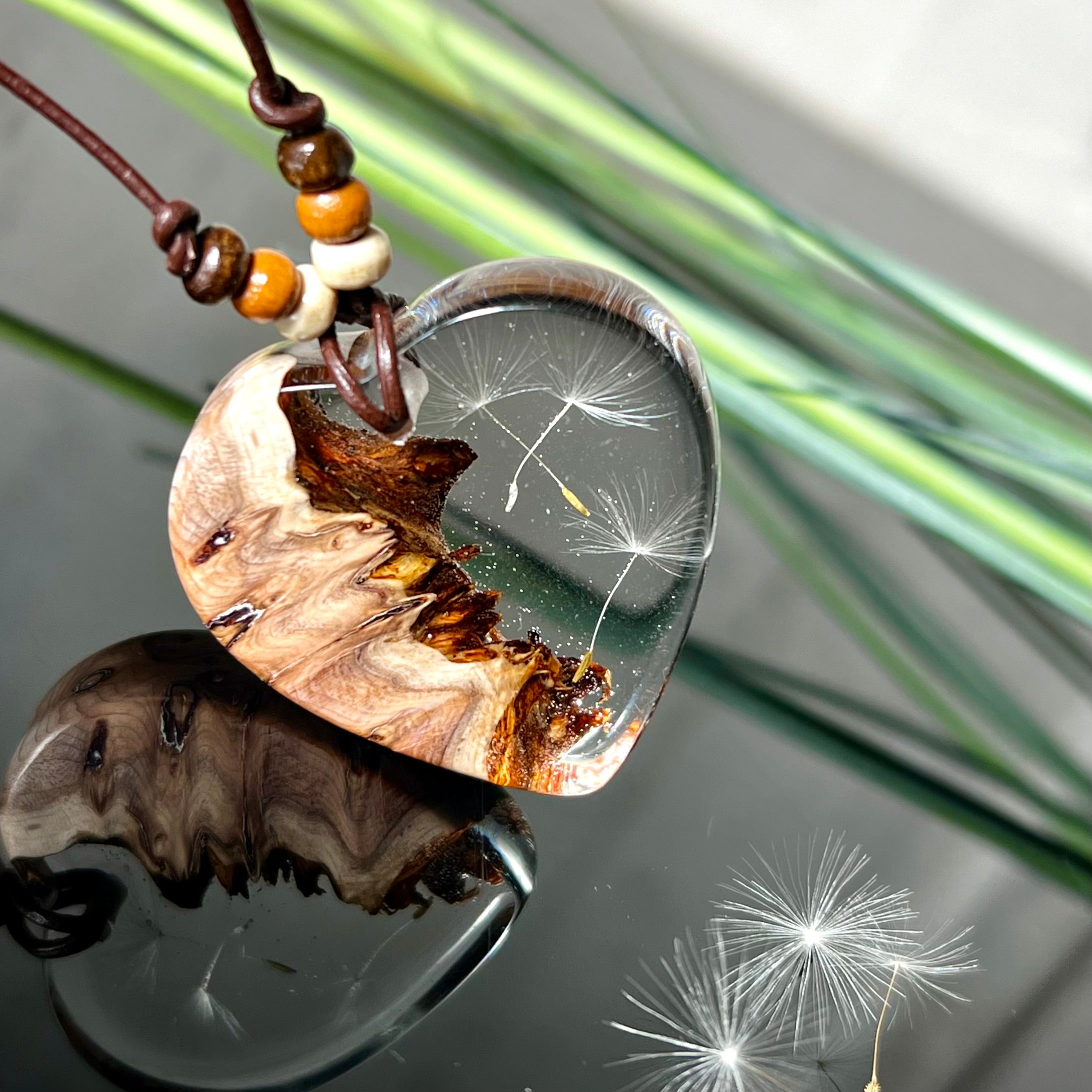 Handgefertigter Herzanhänger Pusteblumenzauber aus Maserholz und klarem Epoxidharz mit echter Pusteblume. Das Design vereint natürliche Maserstrukturen mit der Leichtigkeit schwebender Pusteblumenschirmchen – ein edles, naturverbundenes Schmuckstück mit Symbolkraft. Ideal für Naturliebhaber, Träumer und alle, die das Besondere suchen.