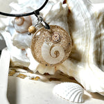 Handgemachter Anhänger mit echter Spirale, kleiner Schnecke, Meersand und feinem Glitzereffekt im Harz. Verziert mit einer Jaspisperle, Edelstahlöse und Lederkette mit Verlängerung. Maritimer Natur-Schmuck, inspiriert vom Ozean