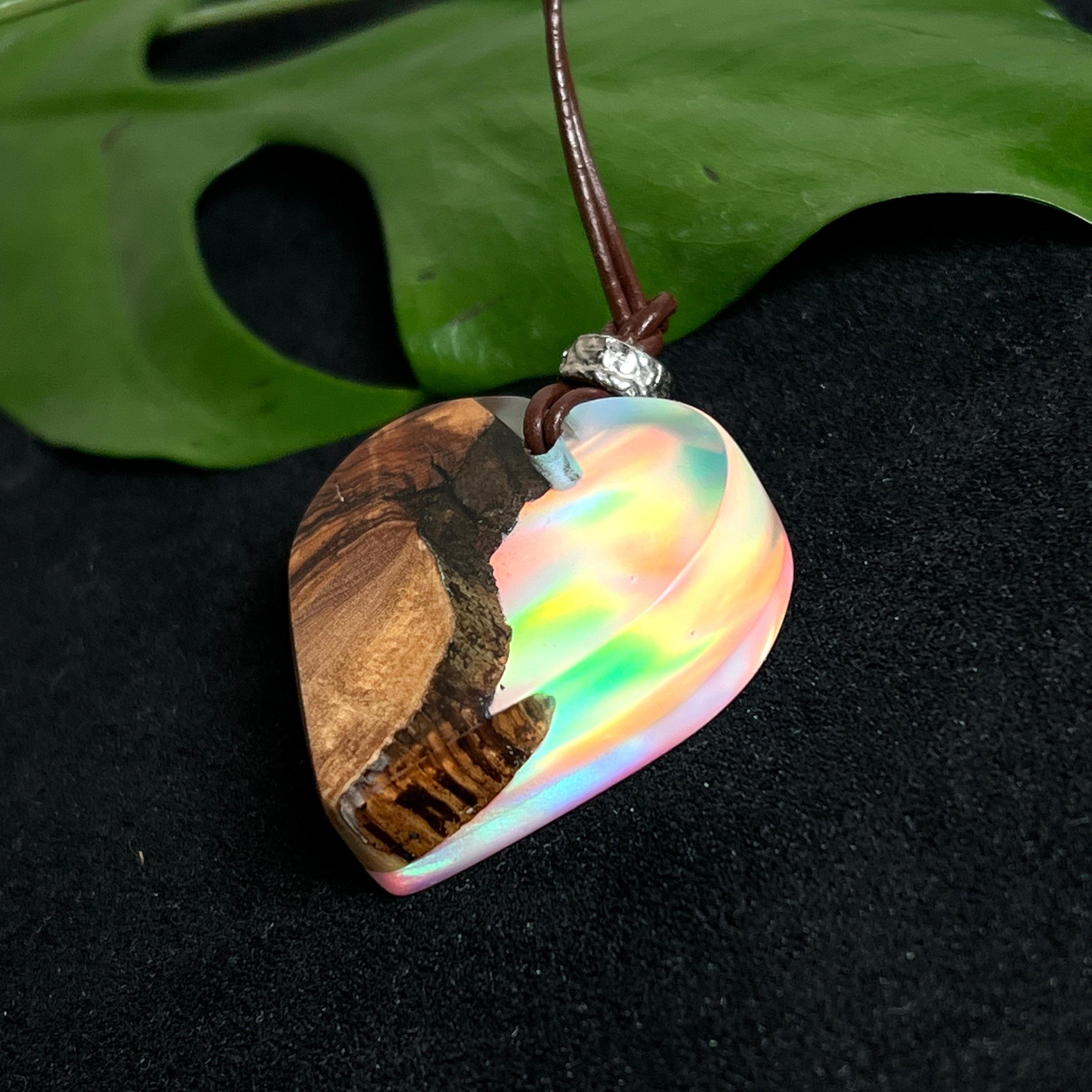 Handgefertigter Herzanhänger aus Olivenholz und schimmerndem Opalharz (Resin Colloidal Imitation Opal) – ein hochwertiges Harz mit feinen, lichtreflektierenden Partikeln, die an echte Opale erinnern. Je nach Licht schimmert der Anhänger in Regenbogenfarben. Mit braunem Lederband und silberfarbener Perle. Jedes Stück ein liebevoll gefertigtes Unikat.