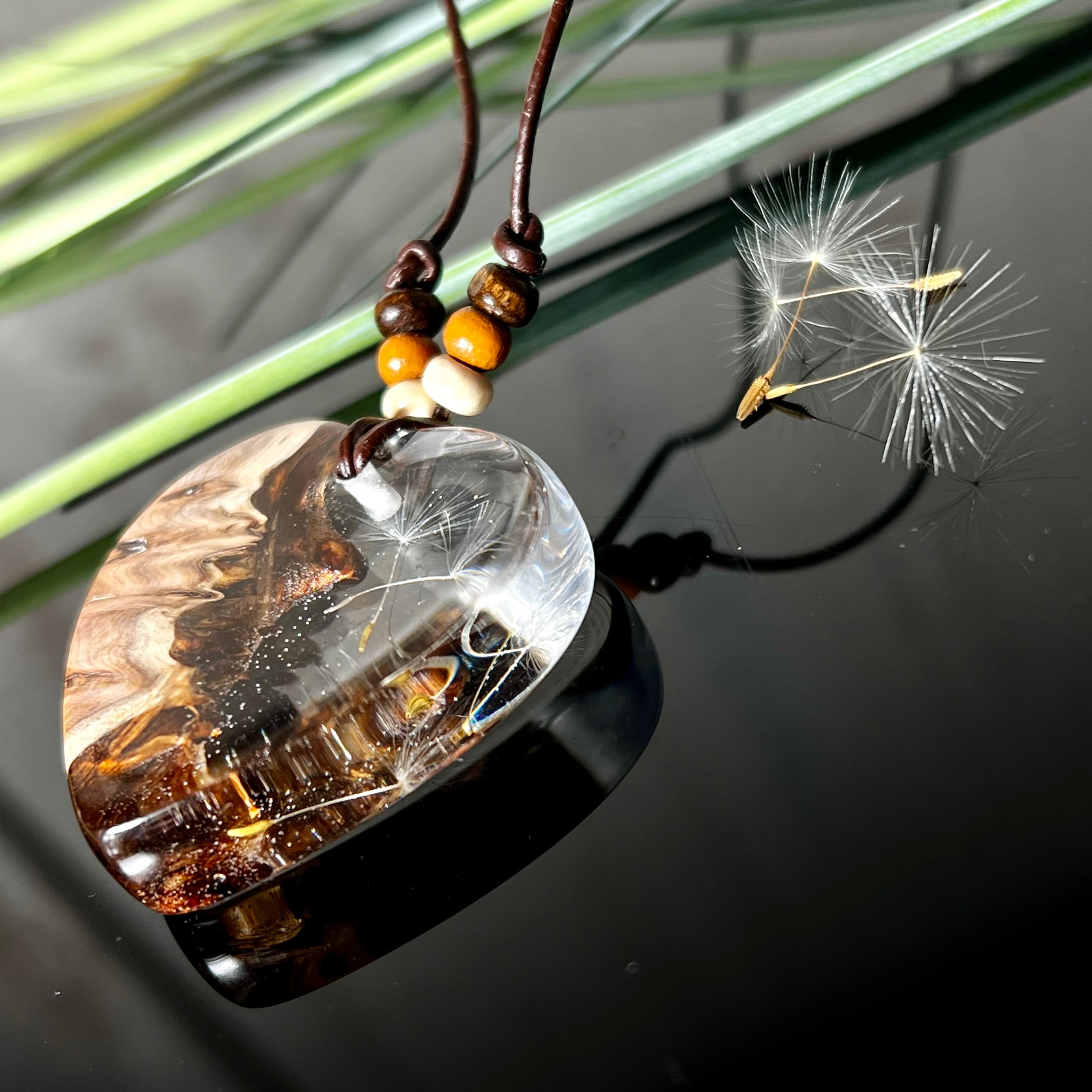 Handgefertigter Herzanhänger Pusteblumenzauber aus Maserholz und klarem Epoxidharz mit echter Pusteblume. Das Design vereint natürliche Maserstrukturen mit der Leichtigkeit schwebender Pusteblumenschirmchen – ein edles, naturverbundenes Schmuckstück mit Symbolkraft. Ideal für Naturliebhaber, Träumer und alle, die das Besondere suchen.