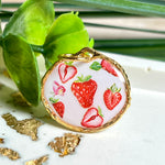 „Handgefertigter Erdbeer Anhänger aus Resin mit zarten Erdbeermotiven, gefasst in 24K vergoldet , glänzender Lünette – sommerlicher Handmade Schmuck und liebevolle Geschenkidee für Frauen und Naturfreunde“