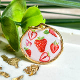 „Handgefertigter Erdbeer Anhänger aus Resin mit zarten Erdbeermotiven, gefasst in 24K vergoldet , glänzender Lünette – sommerlicher Handmade Schmuck und liebevolle Geschenkidee für Frauen und Naturfreunde“