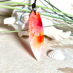 Handgefertigter Surfbrett-Anhänger aus fluoreszierendem Epoxidharz in leuchtenden Orange-, Rot- und Gelbtönen. Leuchtet bei Schwarzlicht. Kombiniert mit verstellbarem Lederband (26–45 cm), verziert mit Spacer- und Holzperlen. Das Design ist inspiriert von der Farbintensität eines Sonnenuntergangs über dem Meer.