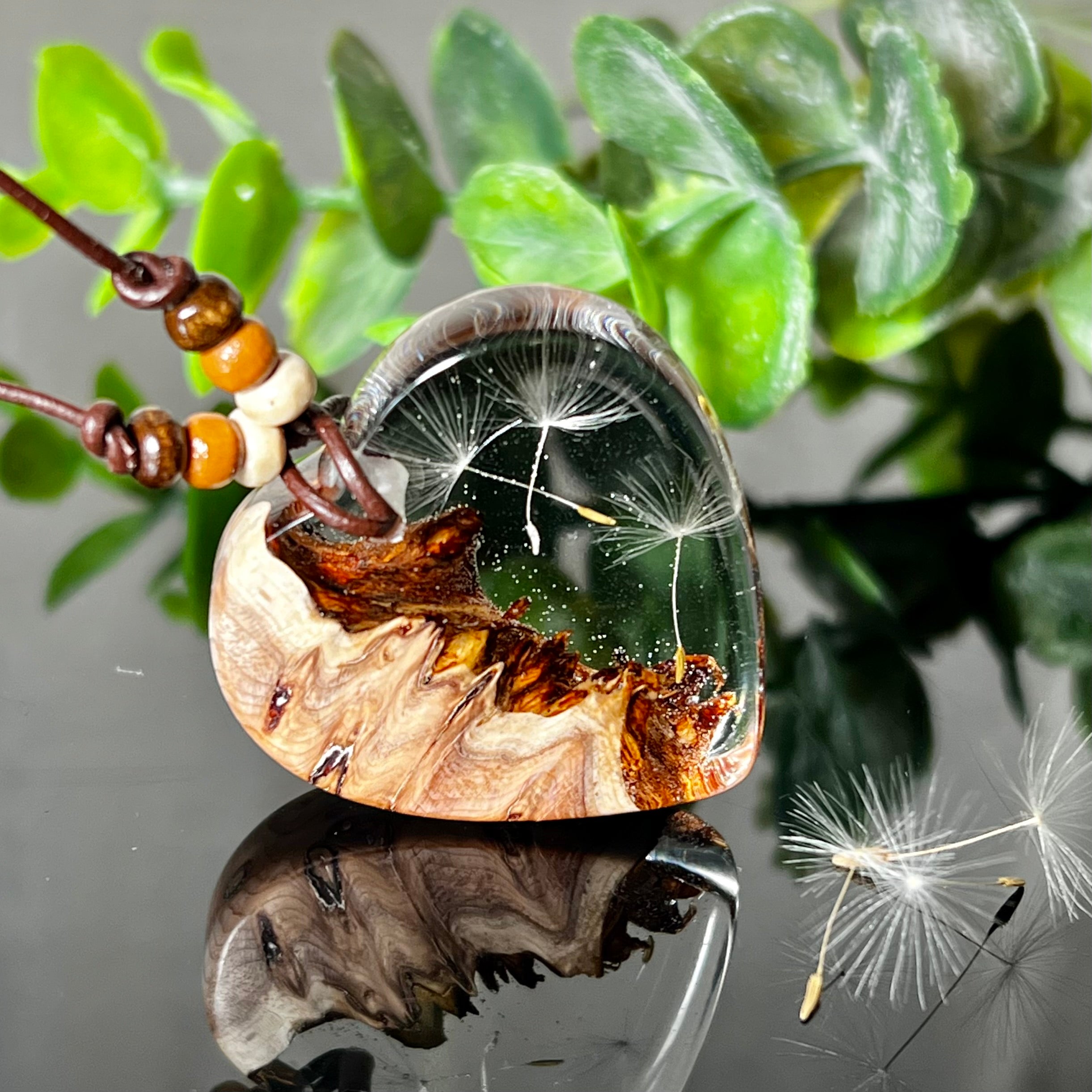 Handgefertigter Herzanhänger Pusteblumenzauber aus Maserholz und klarem Epoxidharz mit echter Pusteblume. Das Design vereint natürliche Maserstrukturen mit der Leichtigkeit schwebender Pusteblumenschirmchen – ein edles, naturverbundenes Schmuckstück mit Symbolkraft. Ideal für Naturliebhaber, Träumer und alle, die das Besondere suchen.