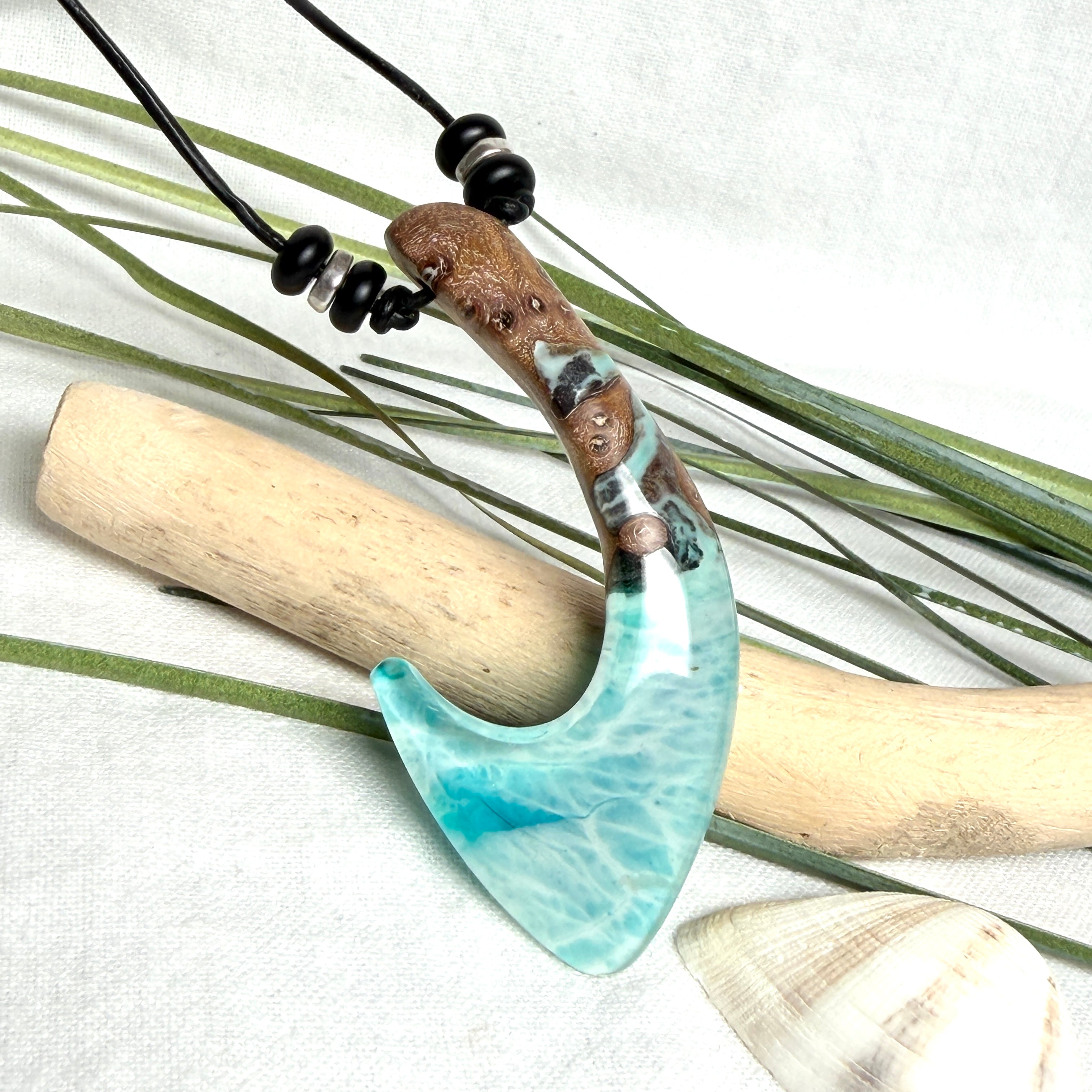Angelhaken Anhänger aus braunem Maserholz und türkis hellblauem Epoxidharz am schwarzen Lederband mit Onyxperlen, Hei Matau Naturschmuck im Māori Stil