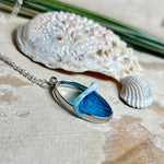 Ovale Halskette „Ocean Crest“ mit 3D-Welle: handgefertigter Harz-Anhänger in Silber-Legierung, Farbverlauf von Tiefblau zu Türkis mit weißer Schaumkrone. Größe ca. 3,9 × 2,3 cm, an einer ca. 56 cm langen versilberten Kette. Glänzende Oberfläche, maritimer Look, Unikat-Handarbeit.