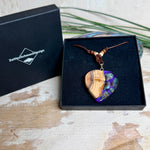 Handgemachter Herzanhänger aus Eibenholz mit lila Harz und Paua-Muschel-Inlay an braunem, verstellbarem Lederband.