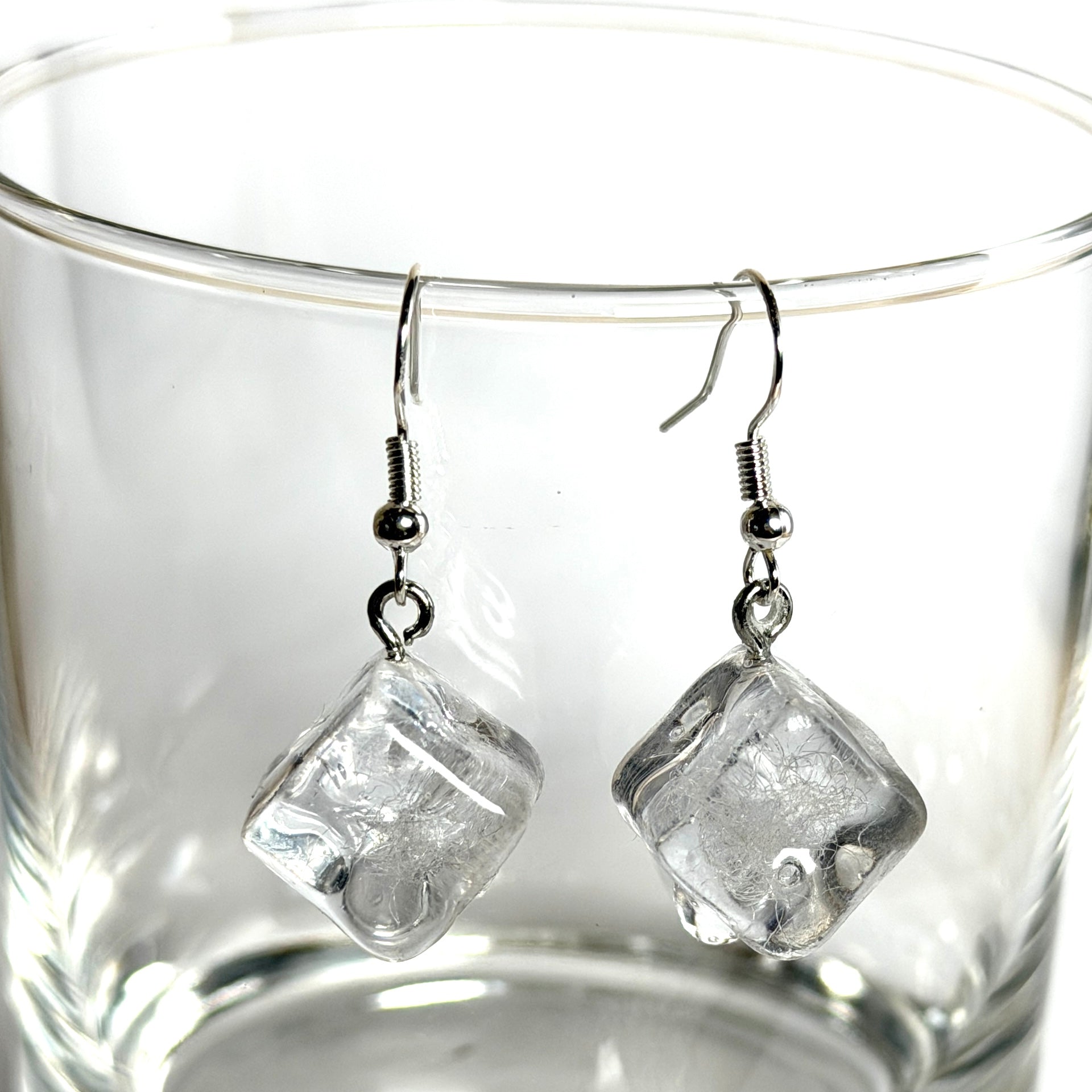 Schmelzende Eiswürfel als Ohrring – handgegossen aus transparentem Epoxidharz, mit 925 Silber Ohrhaken. Ca. 1,3 cm Würfel, Tragelänge ca. 4 cm