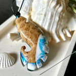 Ocean Nautilus Halskette – handgefertigter Anhänger aus  Epoxidharz und edlem Maserholz in kräftigem Blau, Türkis und Weiß, geformt wie eine stilisierte Nautilus-Muschel. Die einzigartige Maserung des Holzes trifft auf transparente Tiefenwirkung des Harzes. Der ca. 7 cm große Anhänger hängt an einem verstellbaren Lederband mit dekorativen Holzperlen (26–48 cm). Jedes Stück ist ein maritimes Unikat, inspiriert von der Magie des Meeres.